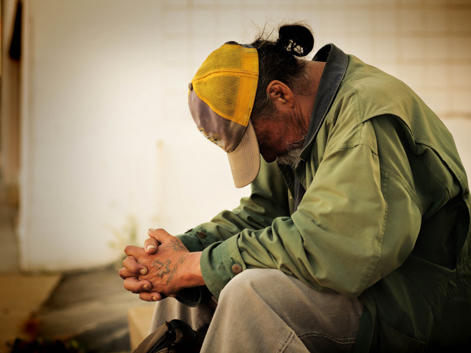 Homeless man praying - poor in spirit - beatitude