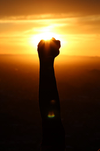 shaking a fist in setting sun